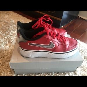 Air Force 1. Red with grey holographic swoosh.